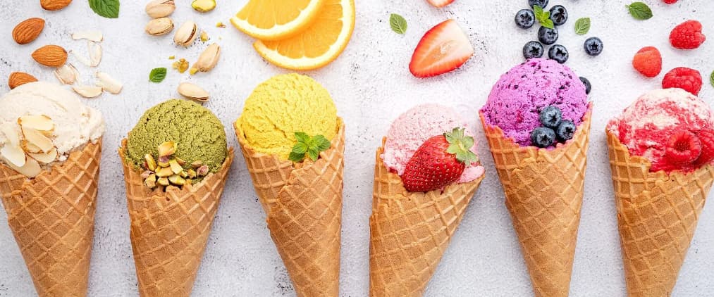 delicious ice cream in waffle cones with fruit flavors